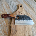 Engraved Chef knife with wooden handle on a wooden cutting board