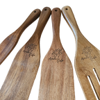 Set of wooden utensils with 'April's Cafe' engraved on handle with a white background