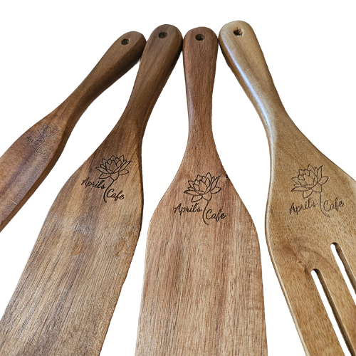 Set of wooden utensils with 'April's Cafe' engraved on handle with a white background